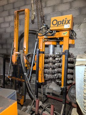 an image of a machine that is working on a piece of metal