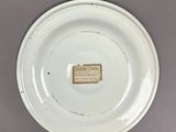 a white plate with a label on it on a table