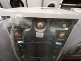 a white washing machine sitting inside of a room