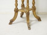 a small table with a marble top on a white floor