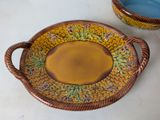a bowl and a plate on a table with a bowl in the background