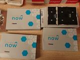 three boxes of electronic devices sitting on a table next to each other