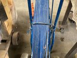 a cart with a hose attached to it in a garage