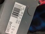 a box with a barcode on it sitting on top of a pile of luggage