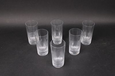six clear glasses sitting on top of a table next to each other