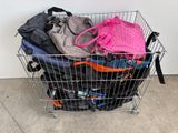 a shopping cart full of clothes and bags on the floor