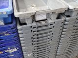many plastic bins stacked on top of each other