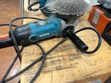 a picture of a drill and a brush sitting on a table