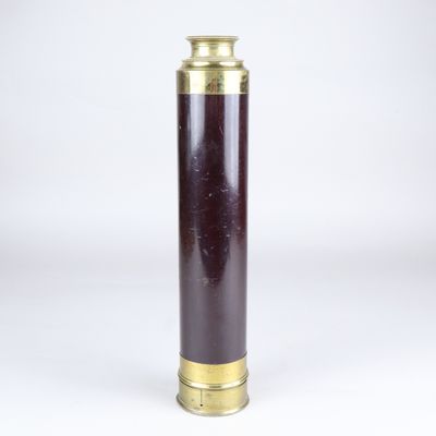 an antique brass and purple glass vase on a white background