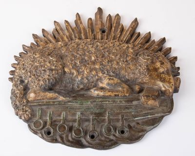 a bronze sculpture of a dog laying on top of a table