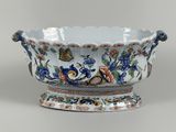 a blue and white bowl with flowers and birds on it