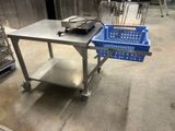 a metal table with a blue basket on top of it