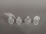 three small glass bottles sitting on top of a table next to each other