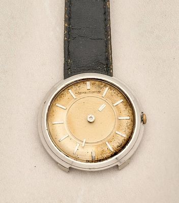a watch that is sitting on a white surface