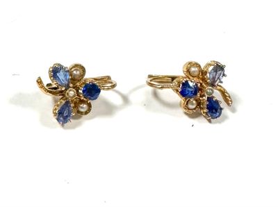 two pairs of earrings with blue and white stones on them