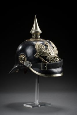 an officer ' s helmet with a gold eagle on it