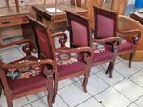 several chairs and a table in a room with a lot of furniture