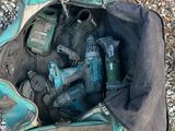 a bag full of tools sitting on the ground