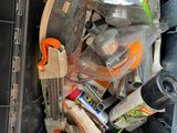 a black trash can filled with assorted items