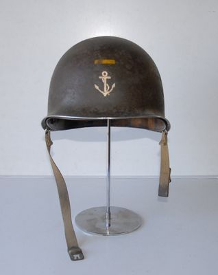 a helmet with an anchor on it sitting on a stand