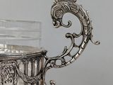a silver cup with a handle and a handle on it