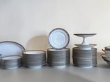 a lot of plates and bowls sitting on a table