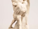 an image of a statue of a man and a woman on a rock