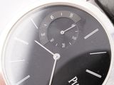 a close up of a wrist watch with a black dial