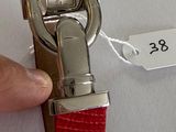 a person that is holding a red watch in their hand