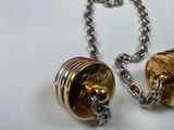 two bells that are attached to a chain on a table
