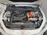 a white car with an orange engine in the trunk