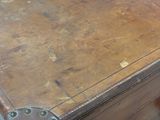 a brown suitcase sitting on top of a wooden table