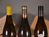 three bottles of wine sitting on a table next to each other