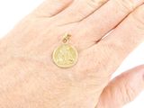 an image of a woman ' s hand with a gold coin on it