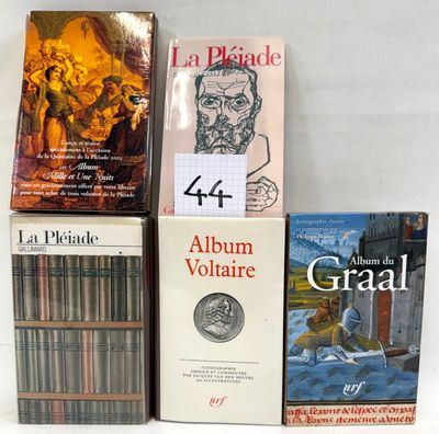 several books are stacked on top of each other on a table
