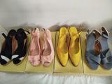 four pairs of women ' s shoes are lined up in a row