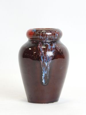 a brown vase with a blue and red design on it