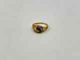 a gold ring with a black stone in the middle
