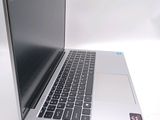 a silver laptop with a black keyboard on a white surface