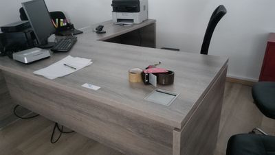 un bureau sur lequel se trouvent un ordinateur portable et une imprimante