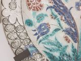 a plate with a floral design on it on a table