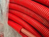 a large pile of red hoses wrapped in plastic