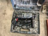 a drill in a tool box on the floor