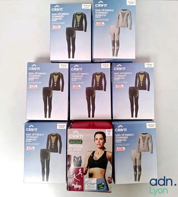 six boxes of clothing sitting on top of each other on a table