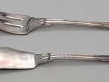 two spoons and a fork on a table