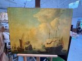 a painting on a easel with a painting of ships in the background