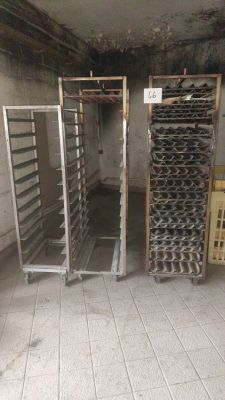 two racks with trays of food in the middle of a room