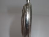 a silver candle that is sitting on a table
