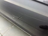 a black car with bullet holes on the side of it