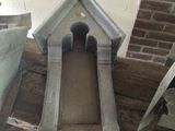 a small dog house made of concrete on the floor